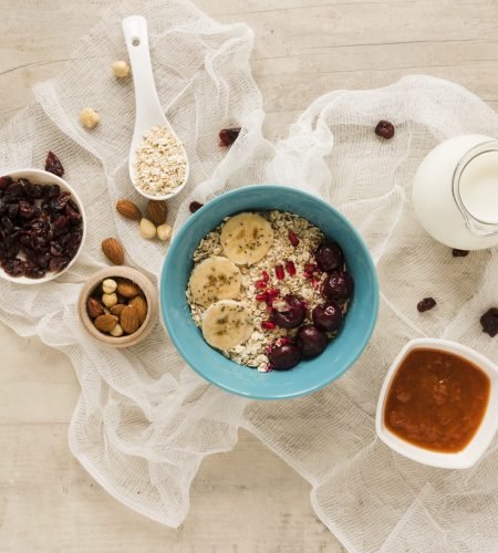 flat-lay-oats-bowl-with-fruits-nuts-milk